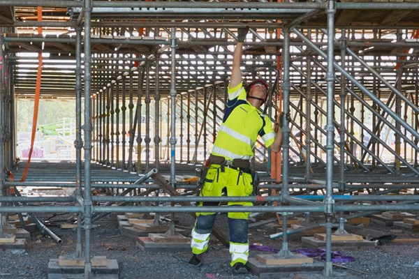 Man in safety equipment working on a construction site. 